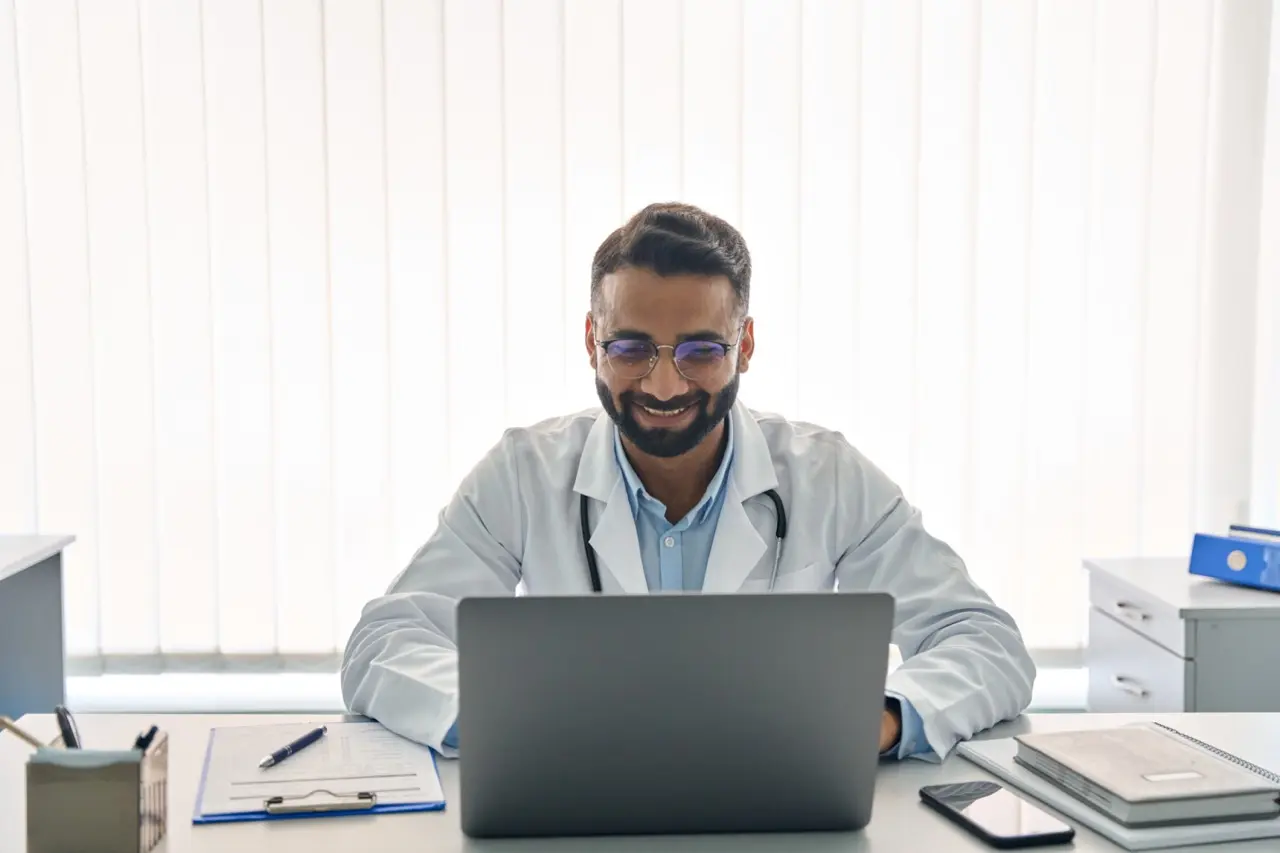 happy doctor using a computer
