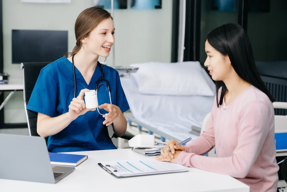 Female doctor explains the use of medication to patient