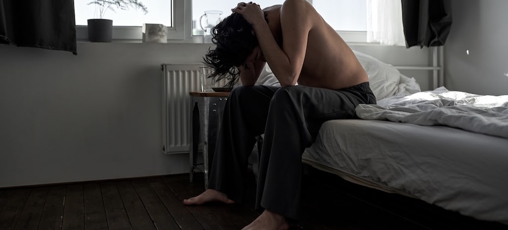 young man depressed, struggling with drug withdrawal and feeling sick