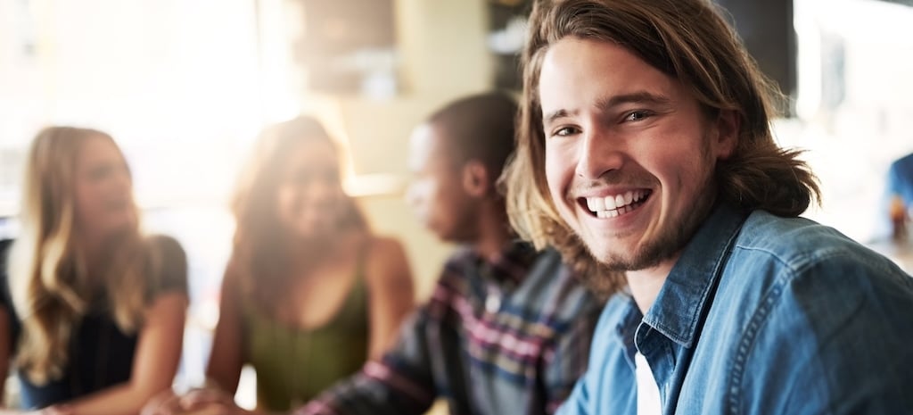 Portrait of a man having coffee with friends in a coffee shop