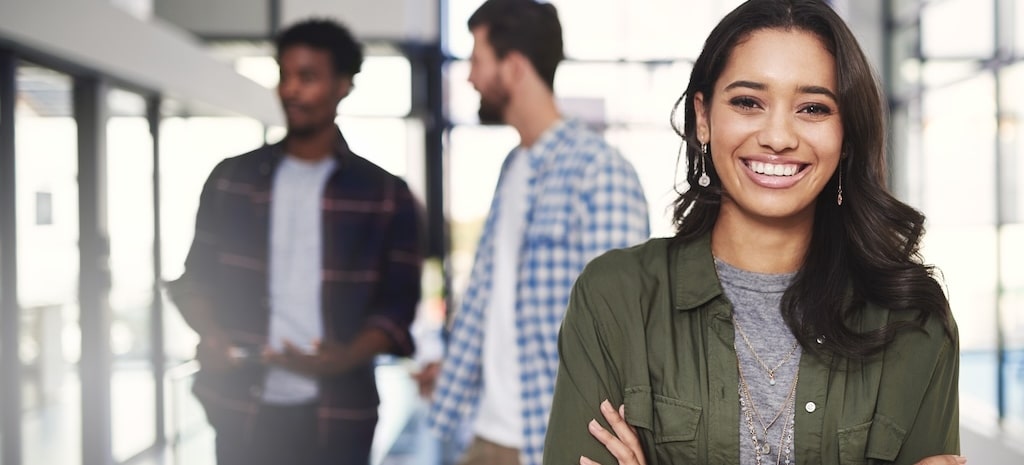 Portrait of a young woman standing in a modern office