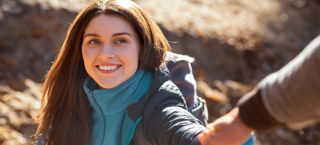 Happy millennial woman reaching for support.