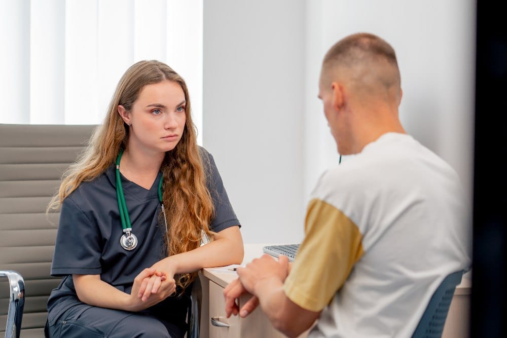 doctor with a stethoscope conducts an appointment with a patient