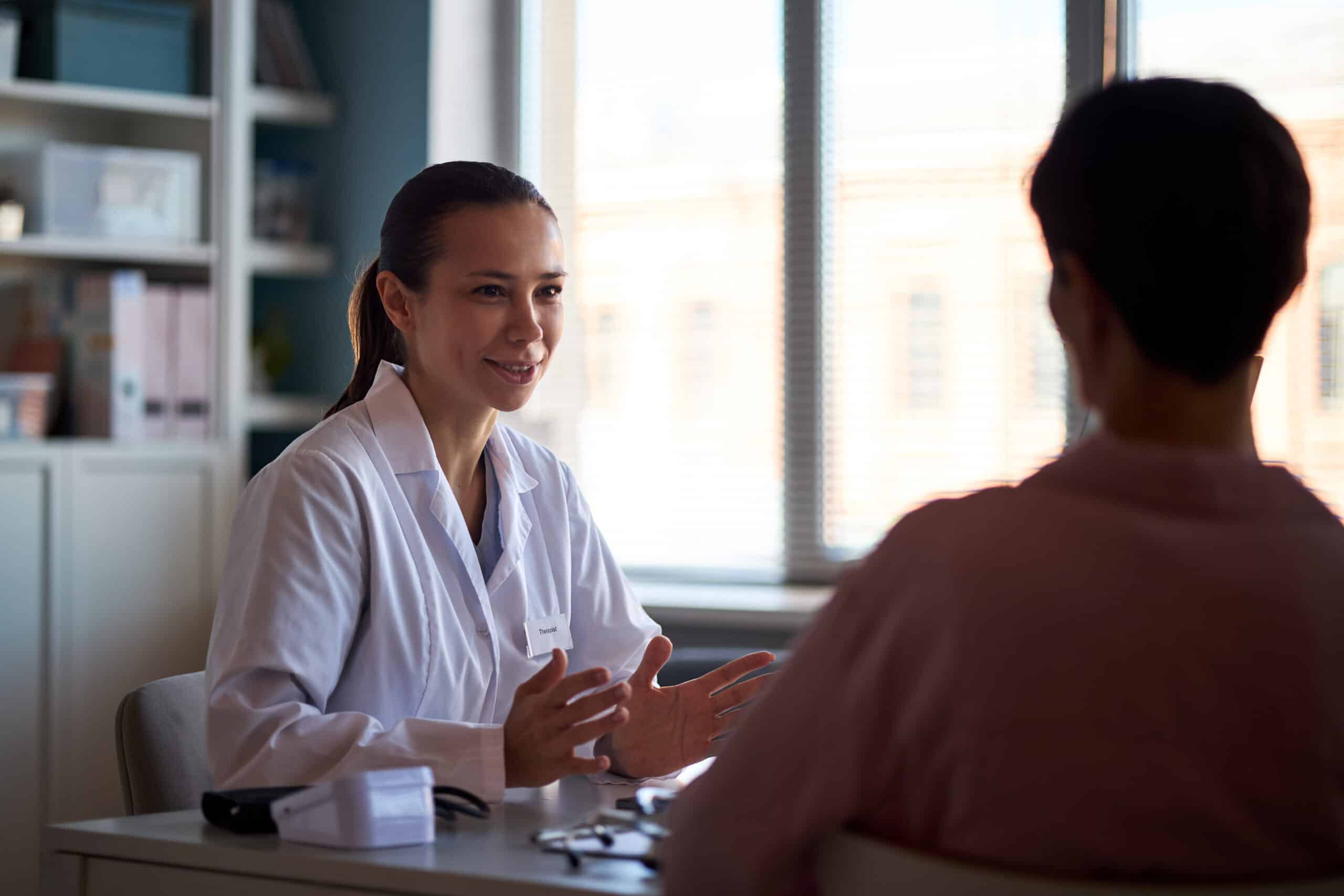 A doctor talking to a patient about medication for alcohol use disorder.