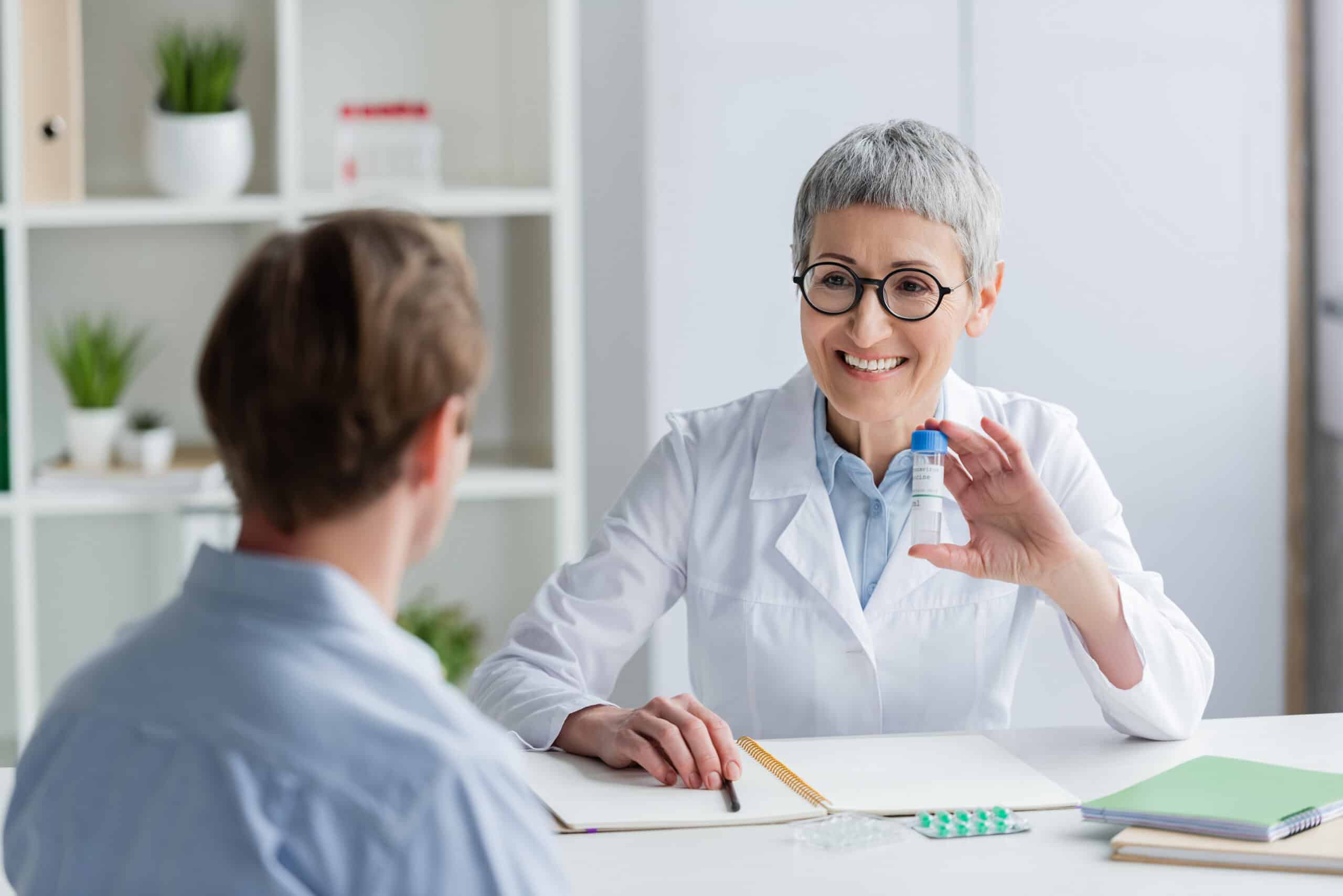 A doctor smiling while speaking with a patient in an office for the topic addiction treatment in colorado.