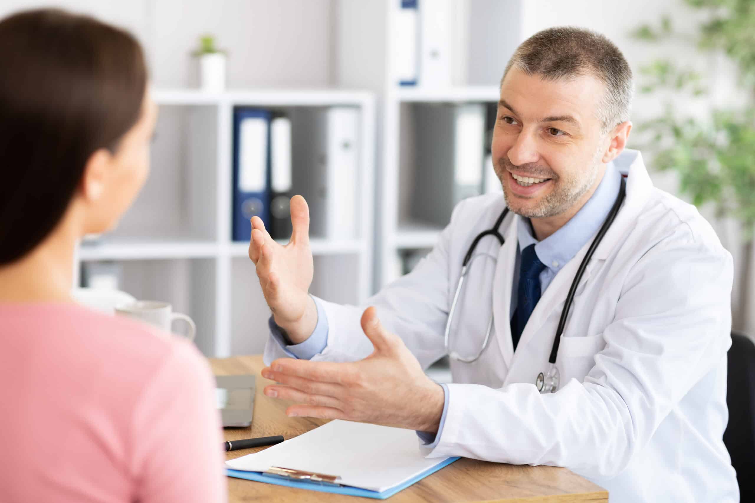 A doctor smiling with a patient while speaking to them about suboxone for addiction.