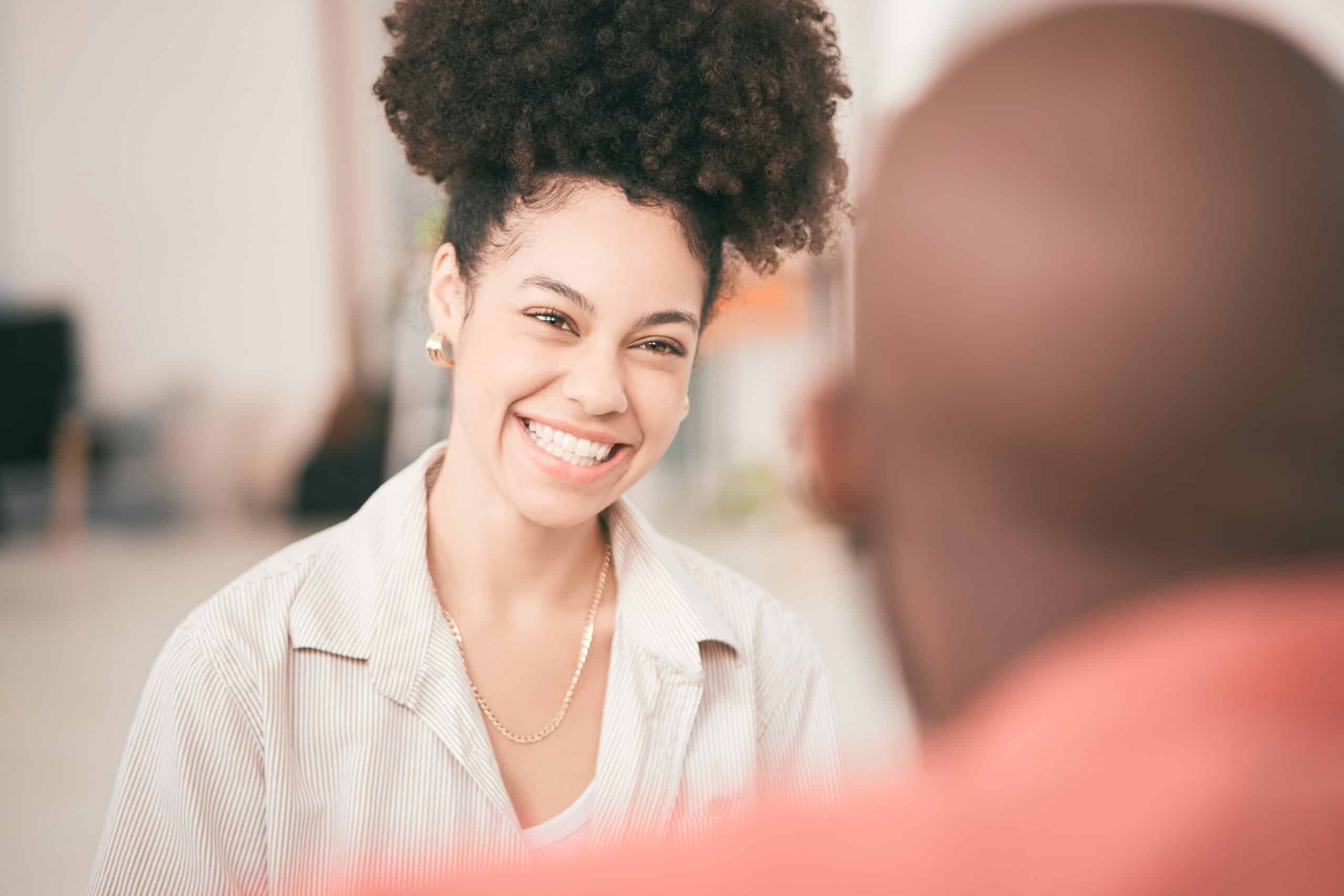 A woman smiling while speaking to a man about how much does suboxone cost without insurance.